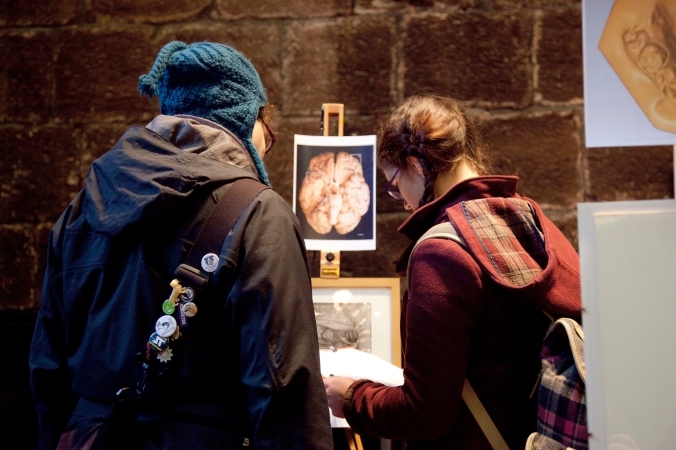 Members of the public interacting with displays produced by Art Gallery and Museum Studies students at the Chetham’s Library exhibition, December 2015